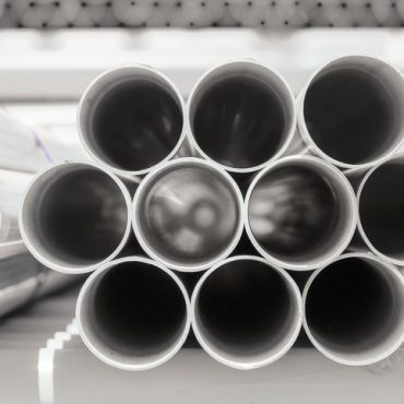 PVC pipes stacked in warehouse.