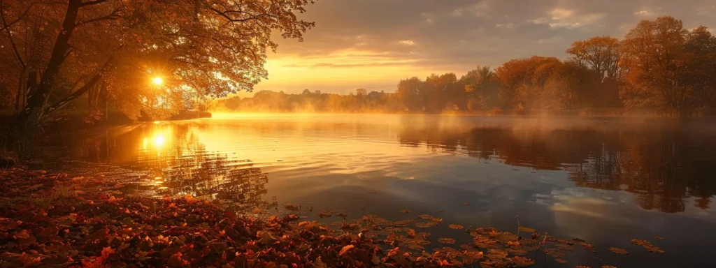 a breathtaking sunrise casts a golden glow over a tranquil lake, with mist rising from the water's surface and vibrant autumn leaves reflecting on the glassy surface.